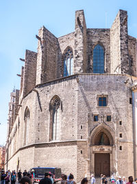 Group of people in historic building against sky