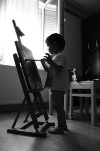 Cute boy painting picture