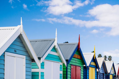 Low angle view of multi colored buildings in city against sky