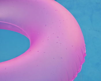 Close-up of pink inflatable ring floating on water in swimming pool