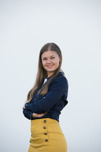 Portrait of a smiling young woman against white background