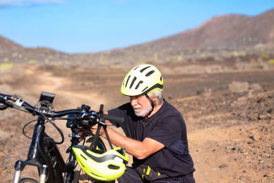 Man with bicycle at desert