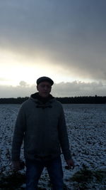 Portrait of man standing in water against sky