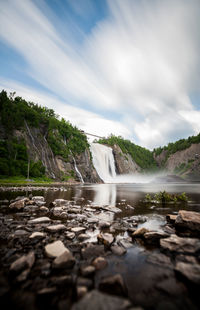 Scenic view of waterfall against sky