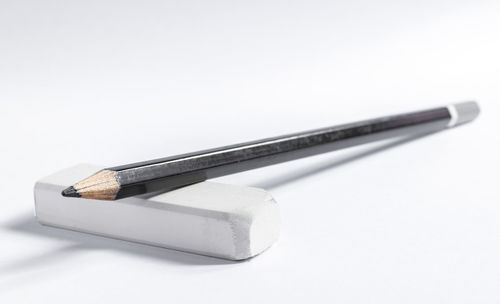 Close-up of pencils over white background