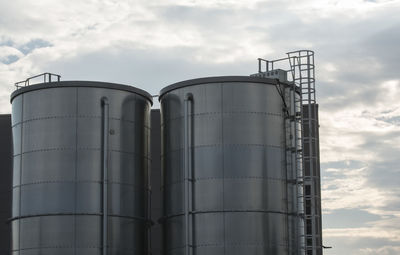 Low angle view of factory against sky