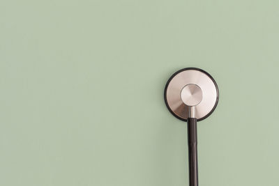 Low angle view of illuminated lamp against wall