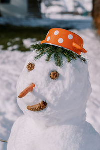 Close-up of snowman on snow