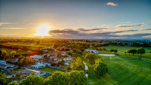Scenic view of field against sky at sunset