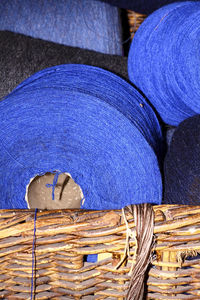 Close-up of blue strings in wicker basket