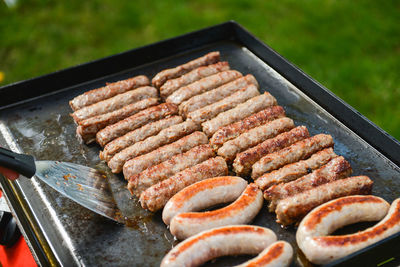 High angle view of sausage on barbecue grill in yard