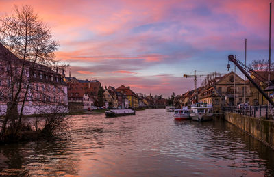 Boats in river with buildings in background