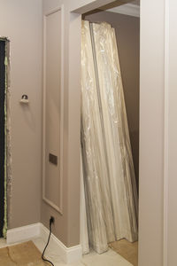 White curtain hanging on wall of house