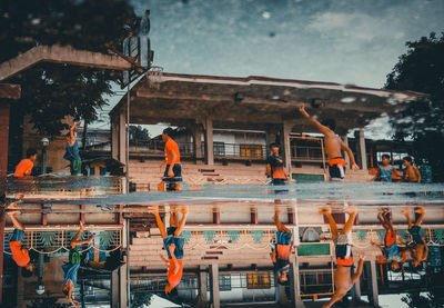 People working on bridge against sky