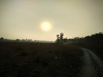 Scenic view of field against clear sky during sunset