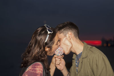 Young couple sharing a candy apple