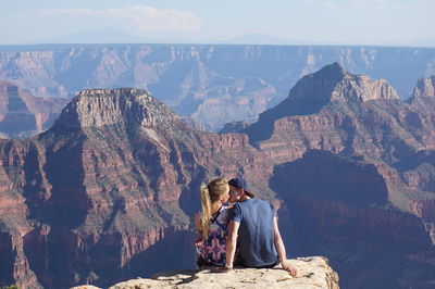 Rear view of people against mountain