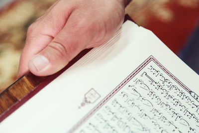 Close-up of hand holding book