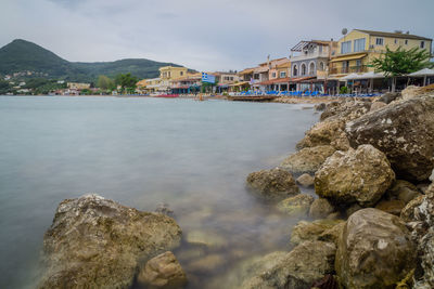 Scenic view of sea and buildings against sky