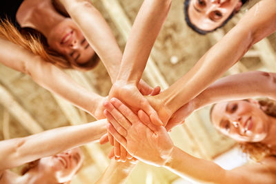 Directly below shot of women stacking hands