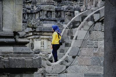 Full length rear view of woman on staircase