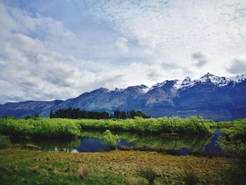 Scenic view of lake and mountains against sky