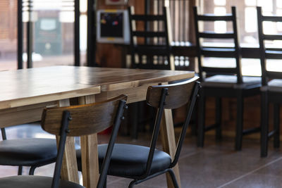 Empty chairs and tables in cafe