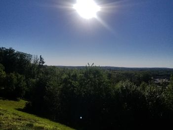 Scenic view of landscape against sky on sunny day