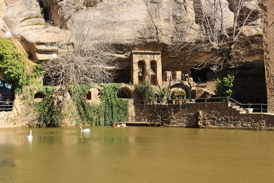 Pond and rocky formation at sant feliu de codines on sunny day