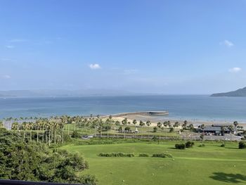 High angle view of townscape by sea against sky