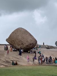 People on beach against sky
