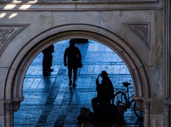 Silhouette of people walking in corridor