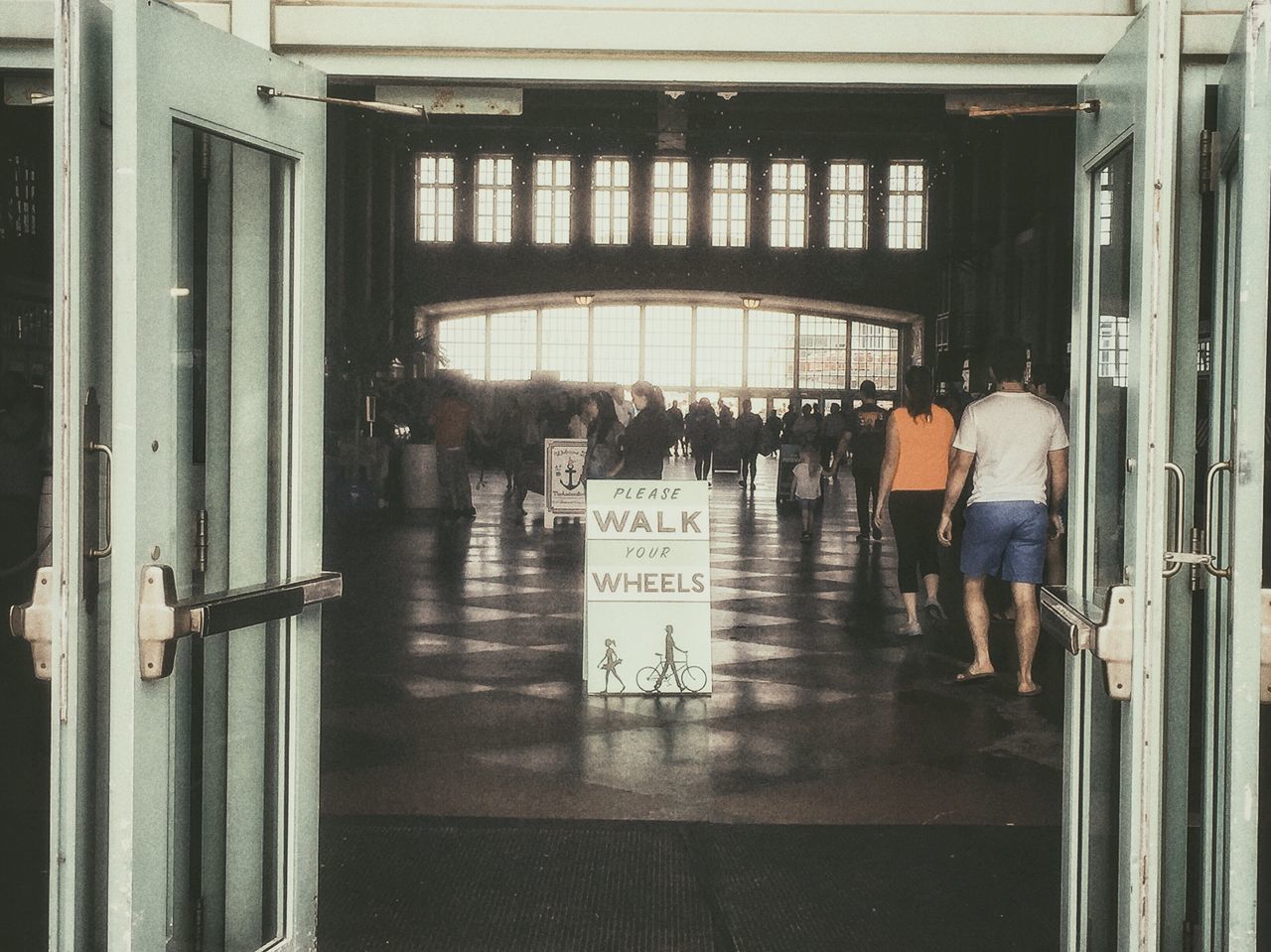 real people, entrance, men, women, lifestyles, indoors, text, door, walking, built structure, waiting, leisure activity, standing, architecture, communication, doorway, full length, day, city, people, adult