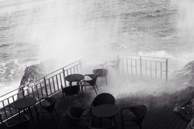 Sea wave splashing on outdoor restaurant