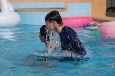 Boys swimming in pool