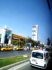 Traffic on city street against clear sky