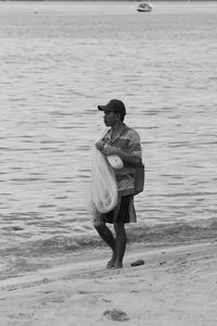 Full length of young man standing on beach