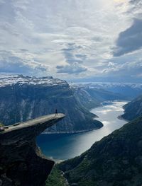 View of trolltunga and the lake below it. i am visibleon top of the trolltunga rock.