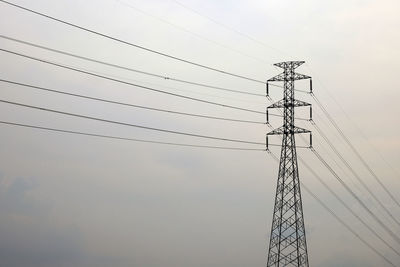 Low angle view of electricity pylon against sky