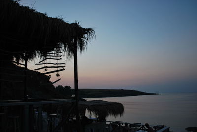 Scenic view of sea against clear sky at sunset