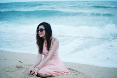 Portrait of smiling young woman on beach