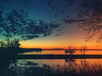 Scenic view of lake against orange sky