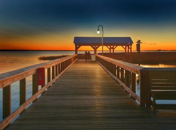 Pier on sea at sunset