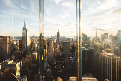 Usa, new york, new york city, midtown manhattan at sunset seen through window