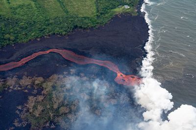 High angle view of kilauea lava flow entering the sea