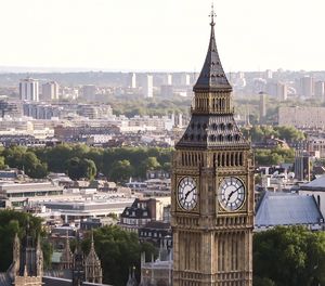 High section of big ben tower against cityscape