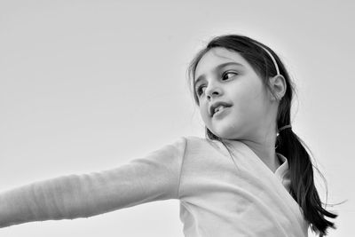Portrait of a girl looking away against white background