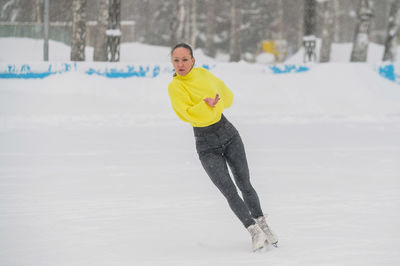 Woman running on snow covered land