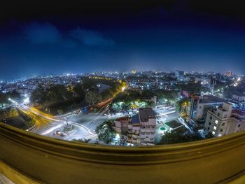 Illuminated cityscape against sky at night