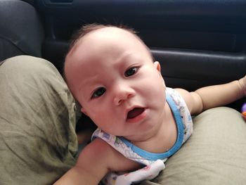 Portrait of cute baby girl in car